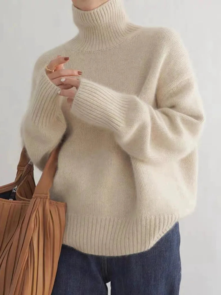 https://cdn.shopify.com/s/files/1/0646/0555/2908/files/Knit-Sweater-Turtleneck-Style-Relaxed-Fit-with-Ribbed-Details.webp?v=1745639140